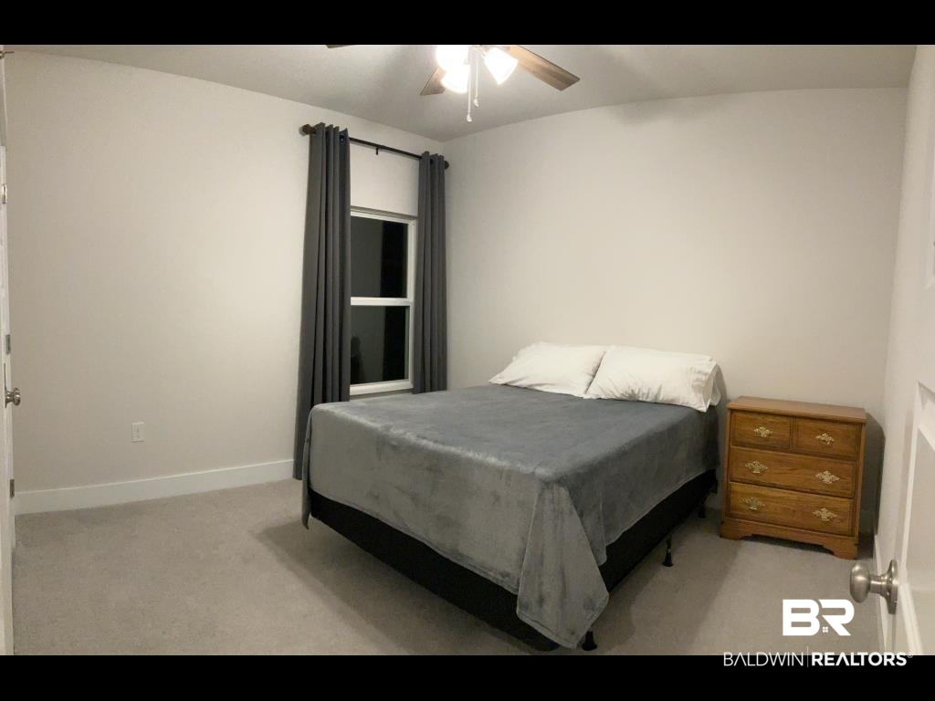 1093 Pheasant Circle Foley, AL 36535 - Photo 18 of 25 Bedroom with light colored carpet and a ceiling fan