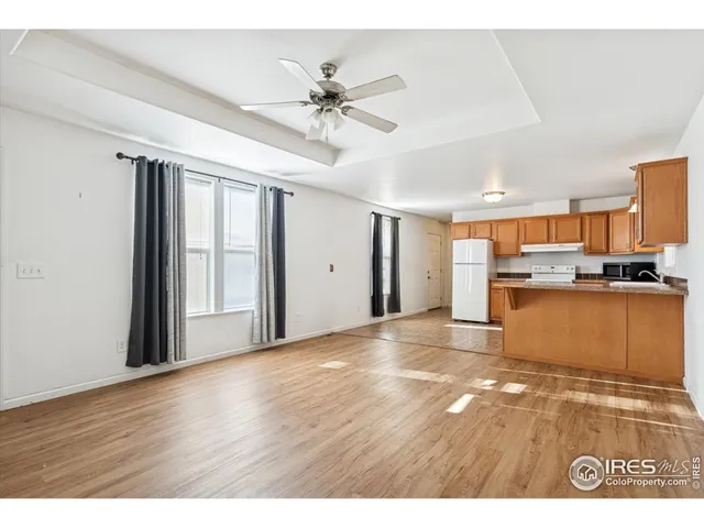a view of a kitchen with wooden cabinet