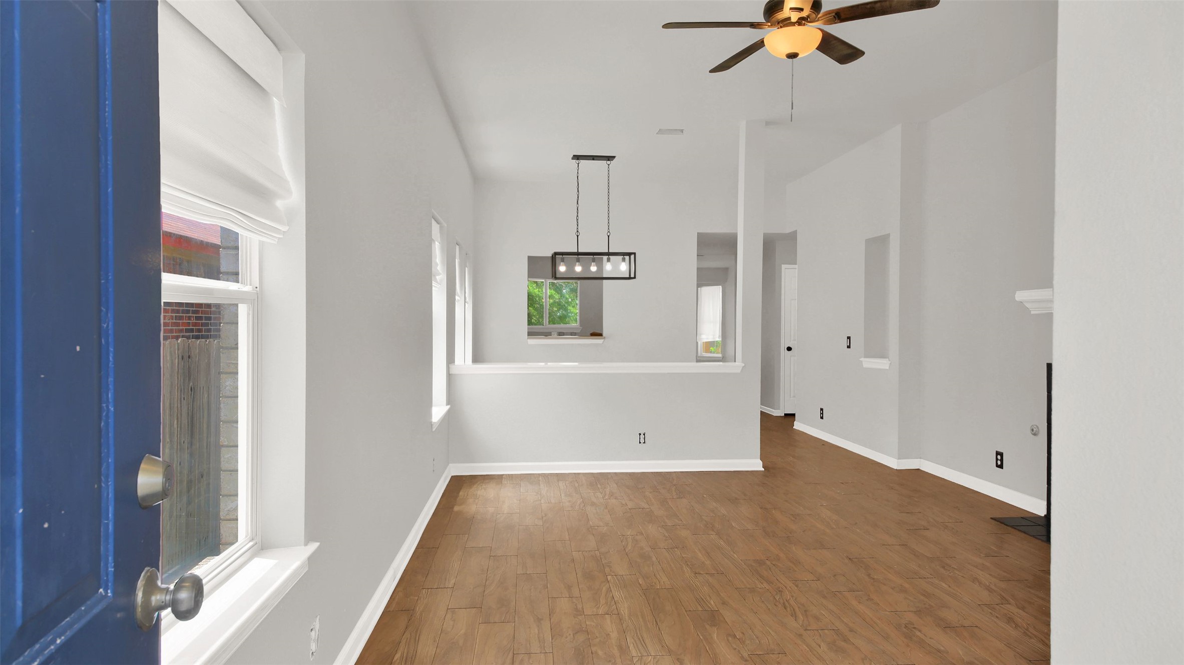 1609 Harness Raceway Street Pflugerville, TX 78660 - Photo 5 of 32 Step inside this well-lit living space, featuring rich tile flooring and a contemporary chandelier.
