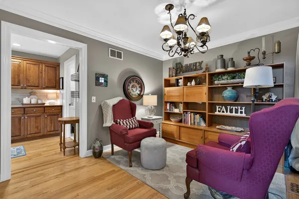 a living room with furniture and a chandelier