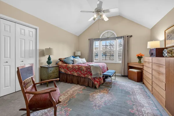 a bedroom with bed and chair