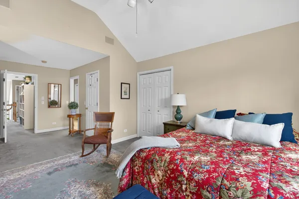 a bedroom with a bed and a lamp