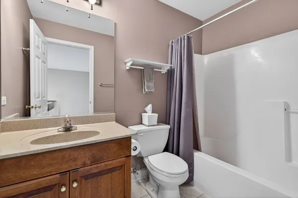 a bathroom with a sink vanity mirror and toilet