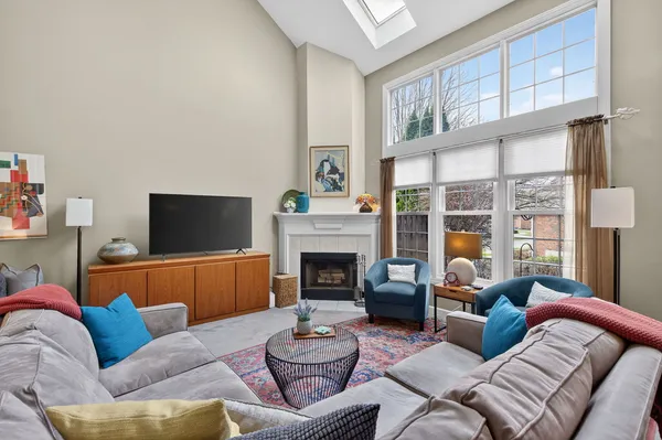 a living room with furniture a ceiling fan and a rug