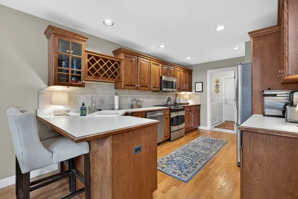 a kitchen with stainless steel appliances granite countertop a stove a sink and a microwave