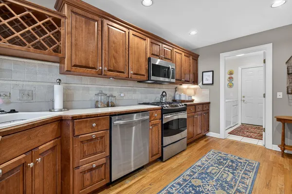 a kitchen with stainless steel appliances granite countertop wooden cabinets a sink and dishwasher