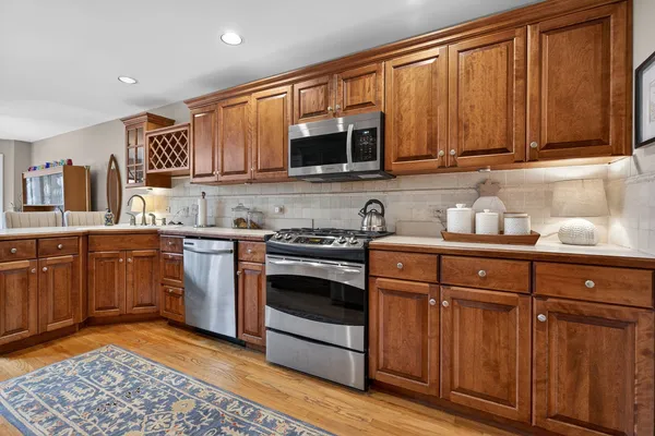 a kitchen with stainless steel appliances granite countertop a refrigerator and a sink