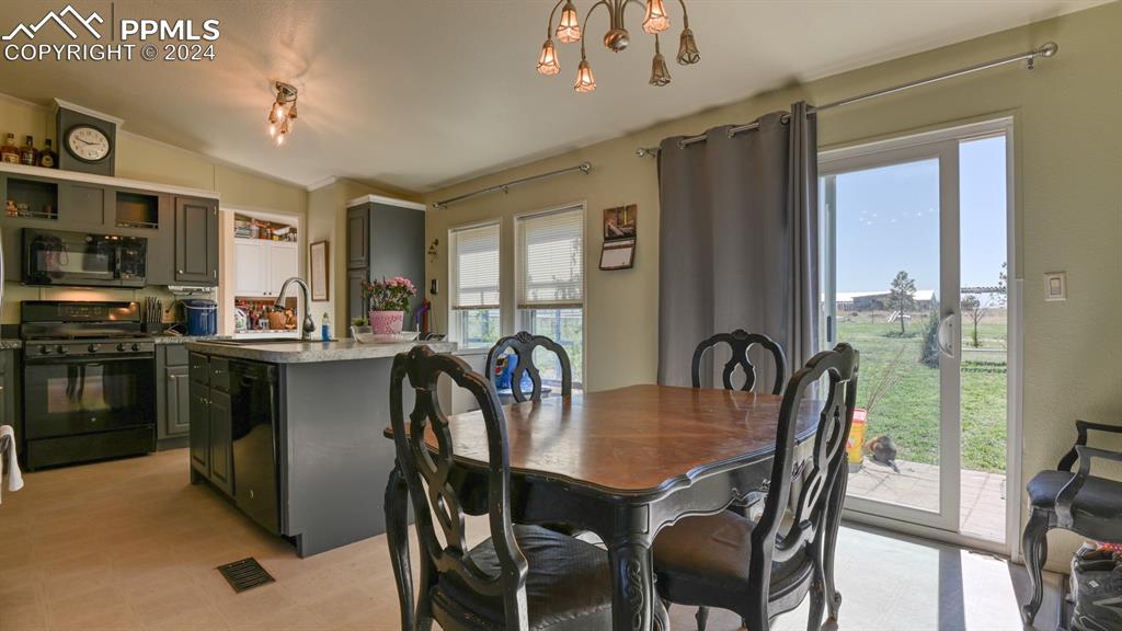 34475 East Jones Road Yoder, CO 80864 - Photo 11 of 31 a dining room with furniture a window and a kitchen
