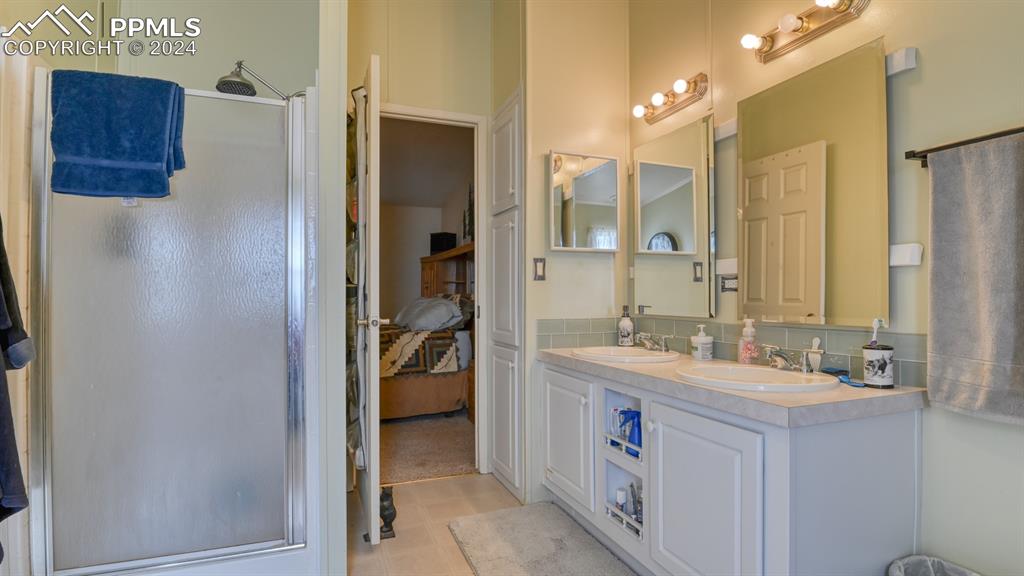 34475 East Jones Road Yoder, CO 80864 - Photo 15 of 31 a bathroom with a sink double vanity and a mirror