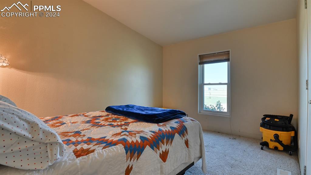 34475 East Jones Road Yoder, CO 80864 - Photo 20 of 31 a bedroom with a bed and a window