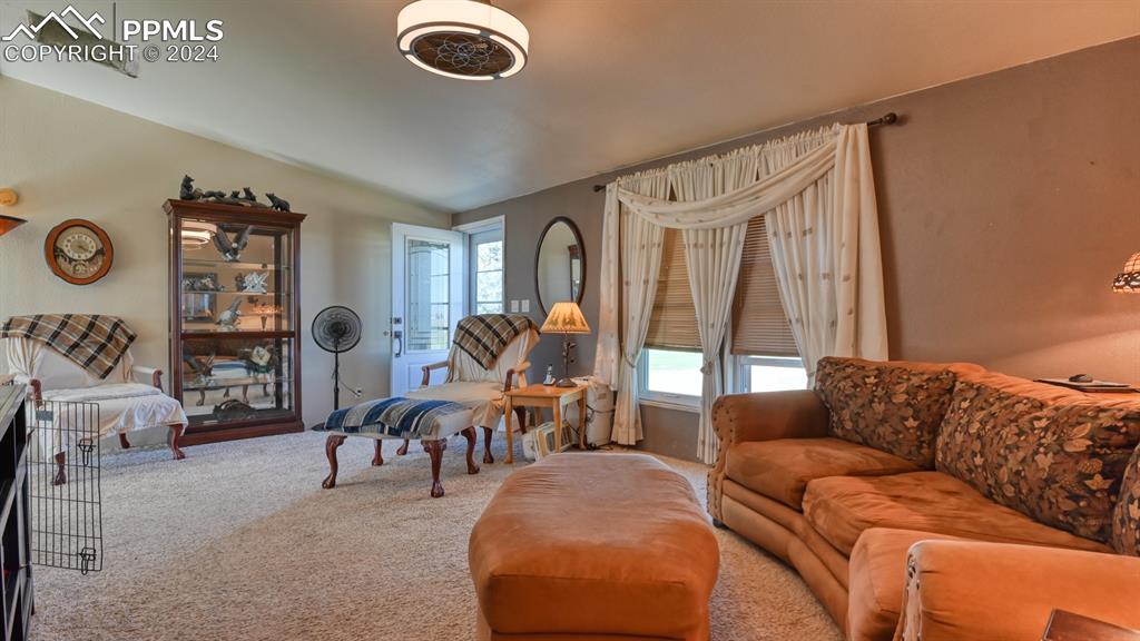 34475 East Jones Road Yoder, CO 80864 - Photo 5 of 31 a living room with furniture a rug and a large window