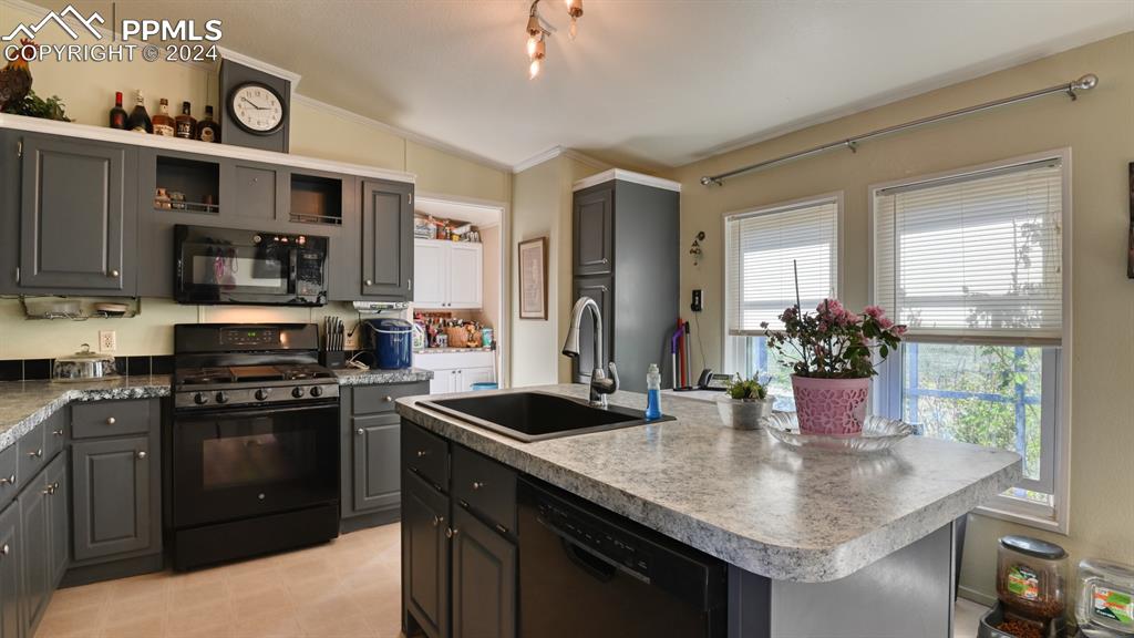 34475 East Jones Road Yoder, CO 80864 - Photo 7 of 31 a kitchen with stainless steel appliances granite countertop a sink a stove and a refrigerator