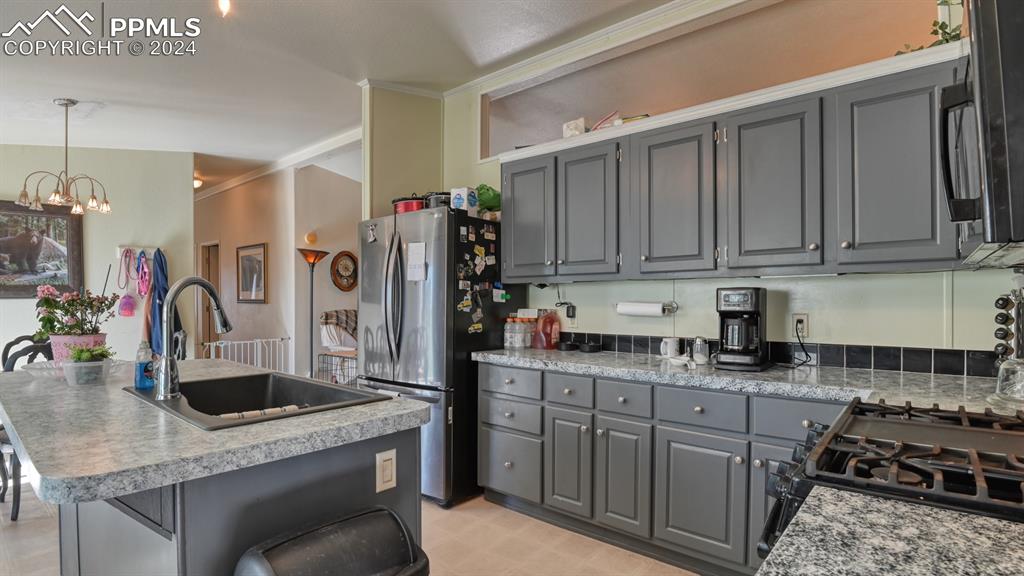 34475 East Jones Road Yoder, CO 80864 - Photo 9 of 31 a kitchen with stainless steel appliances granite countertop a sink stove and refrigerator