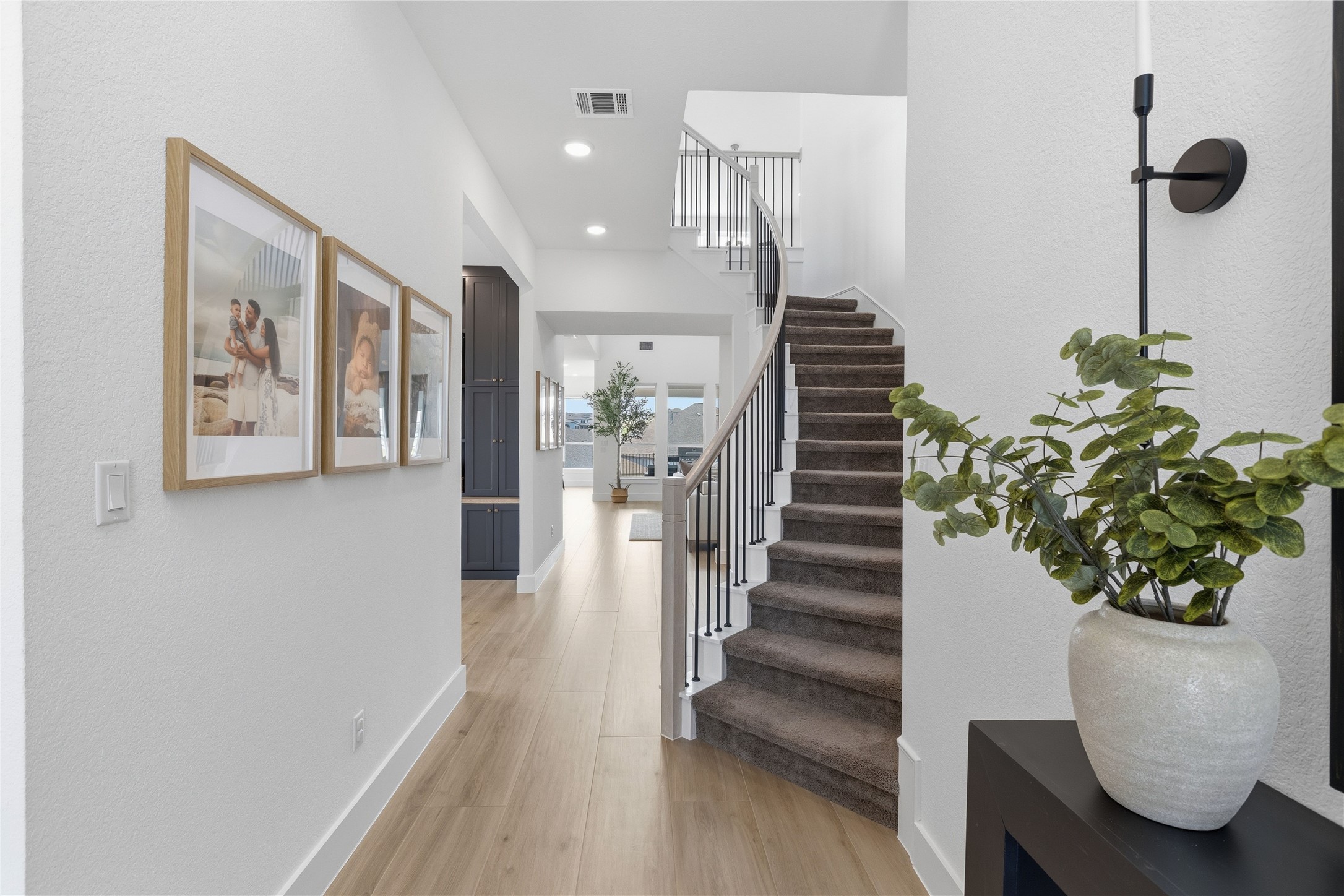 836 Villa Rialto View Leander, TX 78641 - Photo 4 of 33 A graceful staircase with a contemporary railing defines this welcoming entry hall.