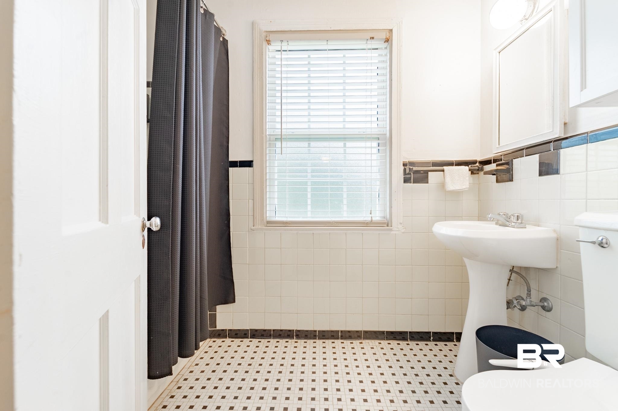 214 Upham Street, Unit 51A Mobile, AL 36607 - Photo 13 of 16 Bathroom with tile patterned floors, tile walls, and toilet
