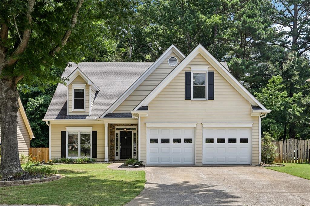 a front view of a house with a garden