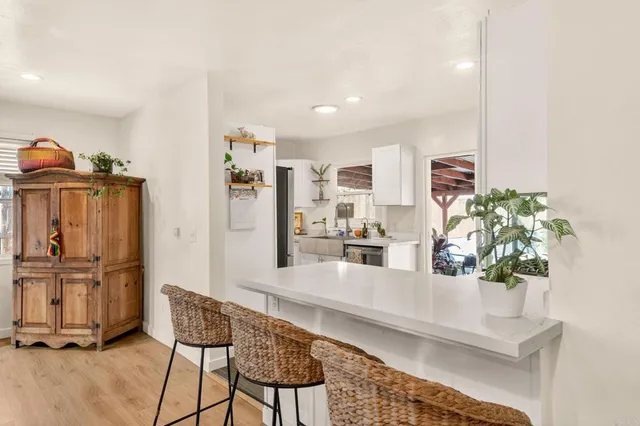 a living room with furniture and a kitchen view