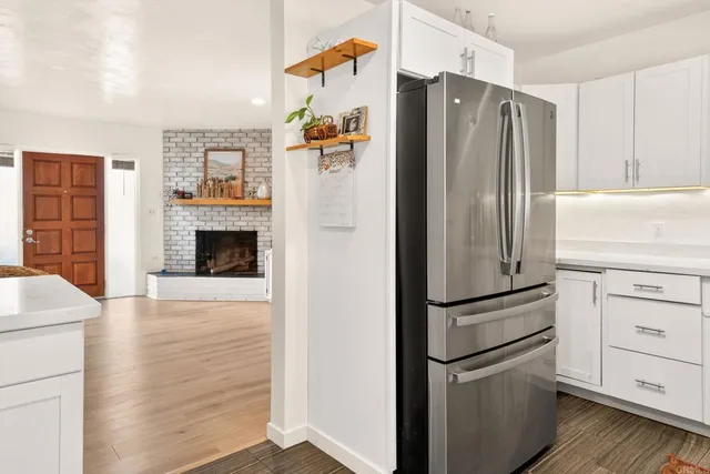 a kitchen with stainless steel appliances a refrigerator a stove and cabinets