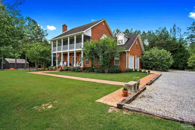 a front view of a house with a yard table and chairs