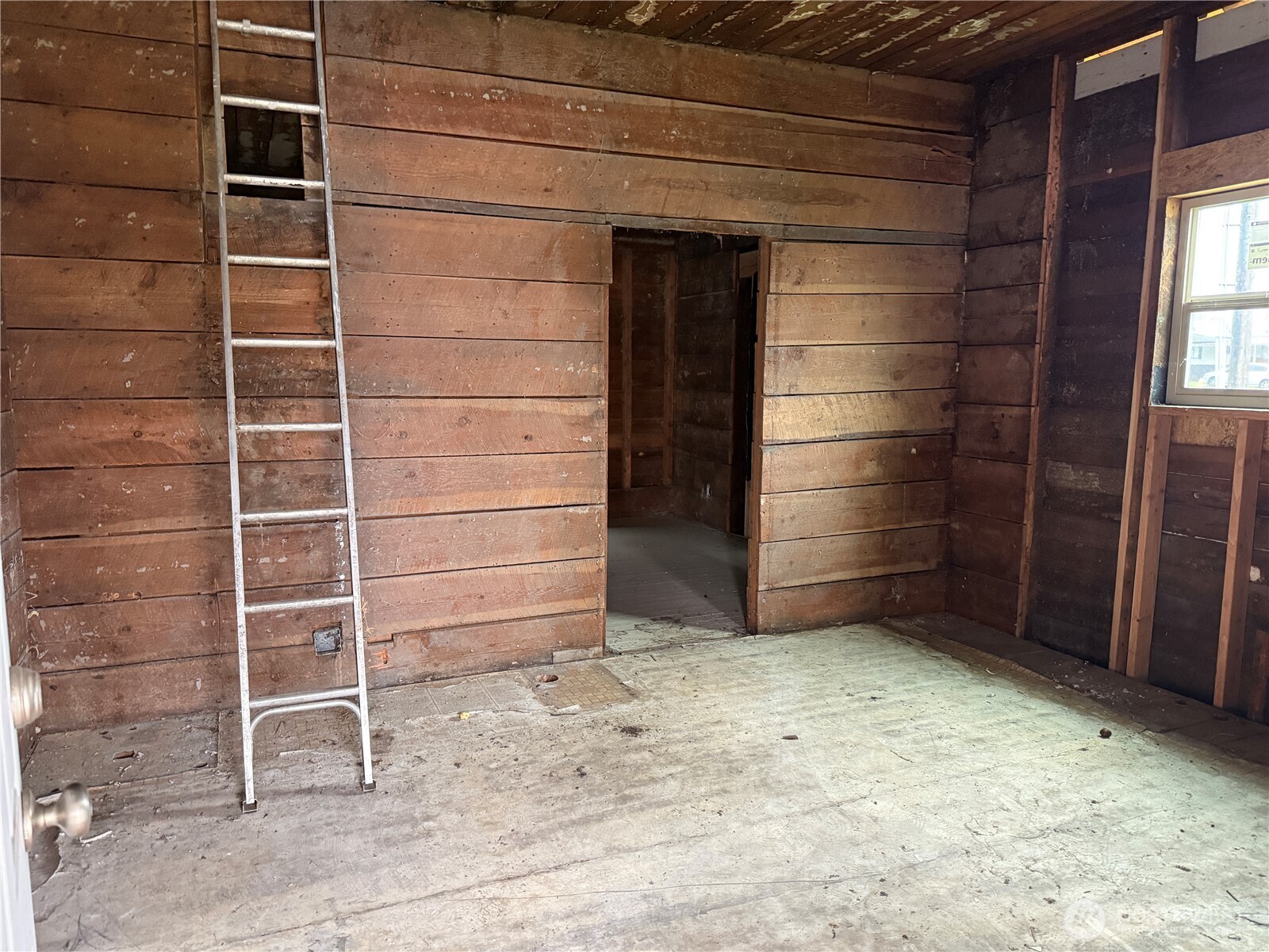490 West Spruce Street Sequim, WA 98382 - Photo 5 of 18 a view of an empty room and wooden shelves