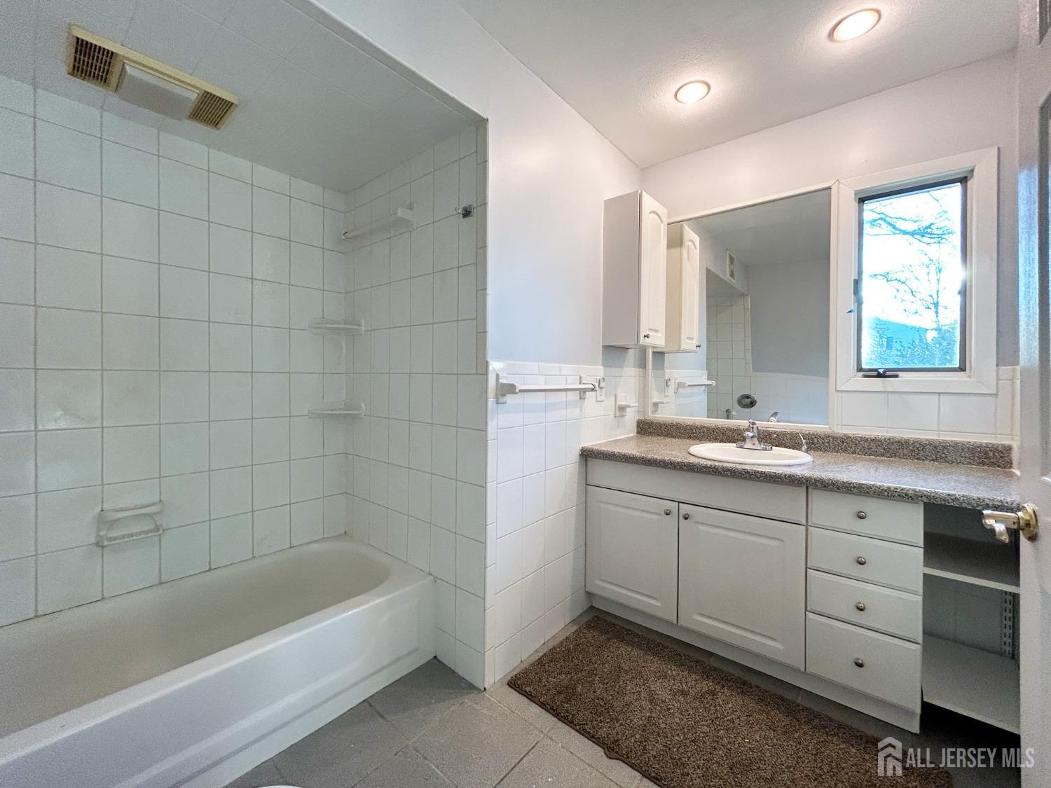 122 Vineyard Road Edison, NJ 08817 - Photo 12 of 19 a bathroom with a tub sink and mirror