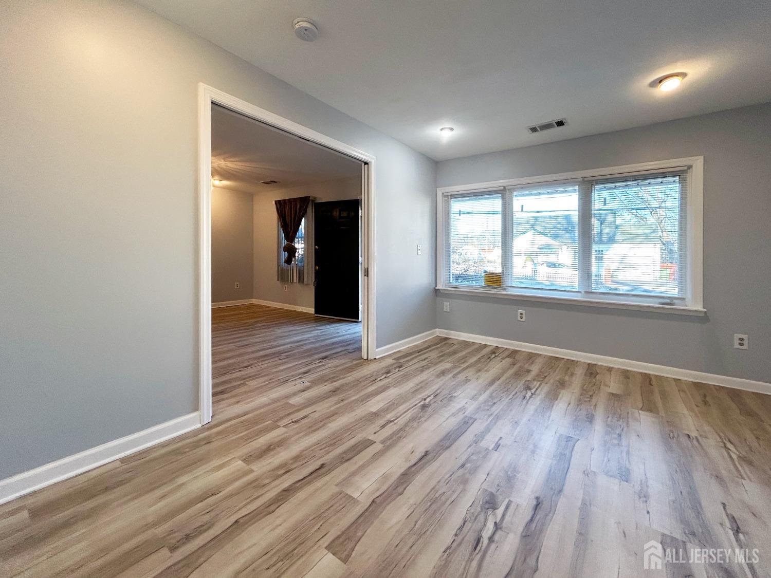 122 Vineyard Road Edison, NJ 08817 - Photo 14 of 19 an empty room with wooden floor and windows