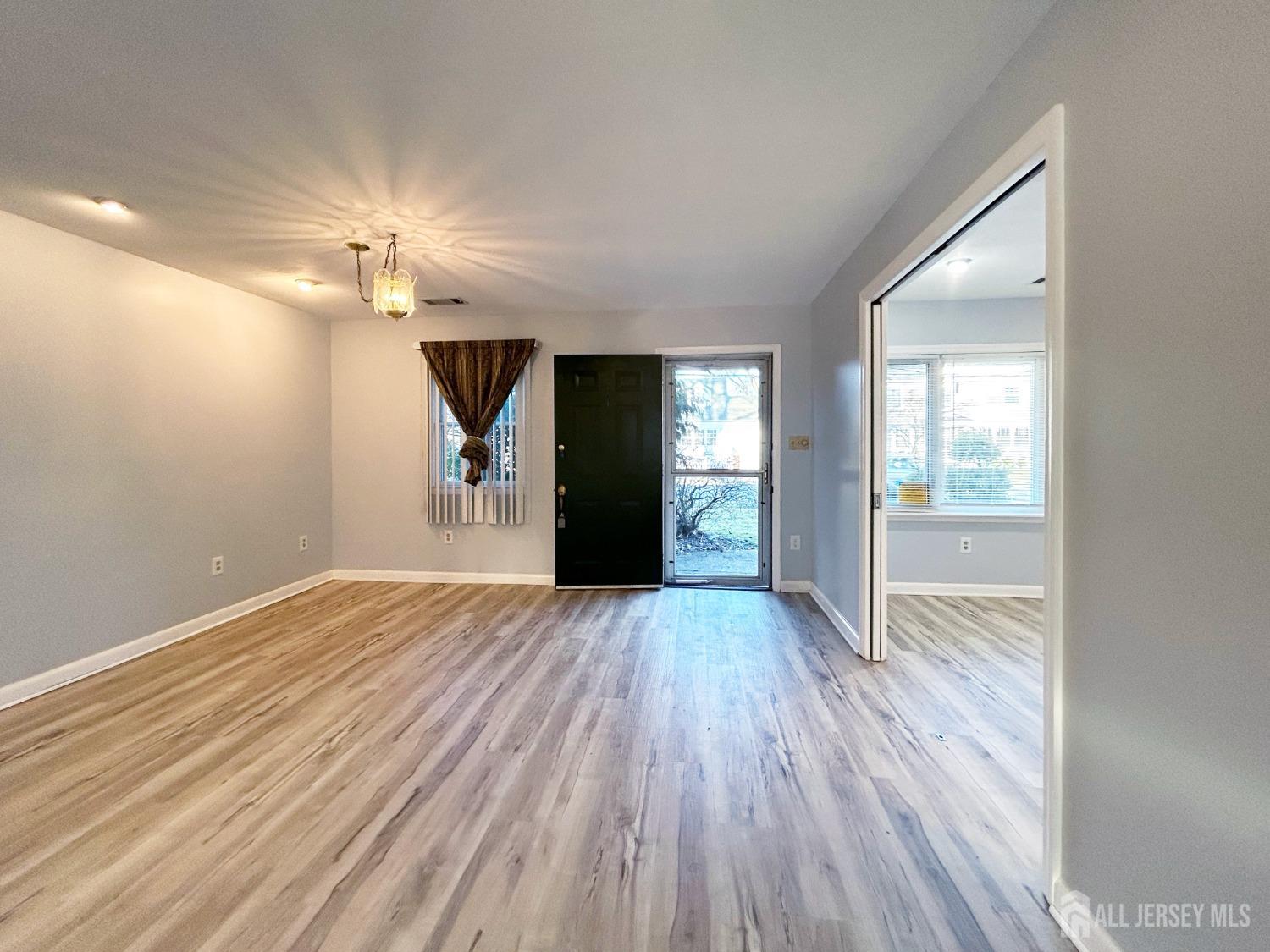 122 Vineyard Road Edison, NJ 08817 - Photo 6 of 19 wooden floor in an empty room with a window