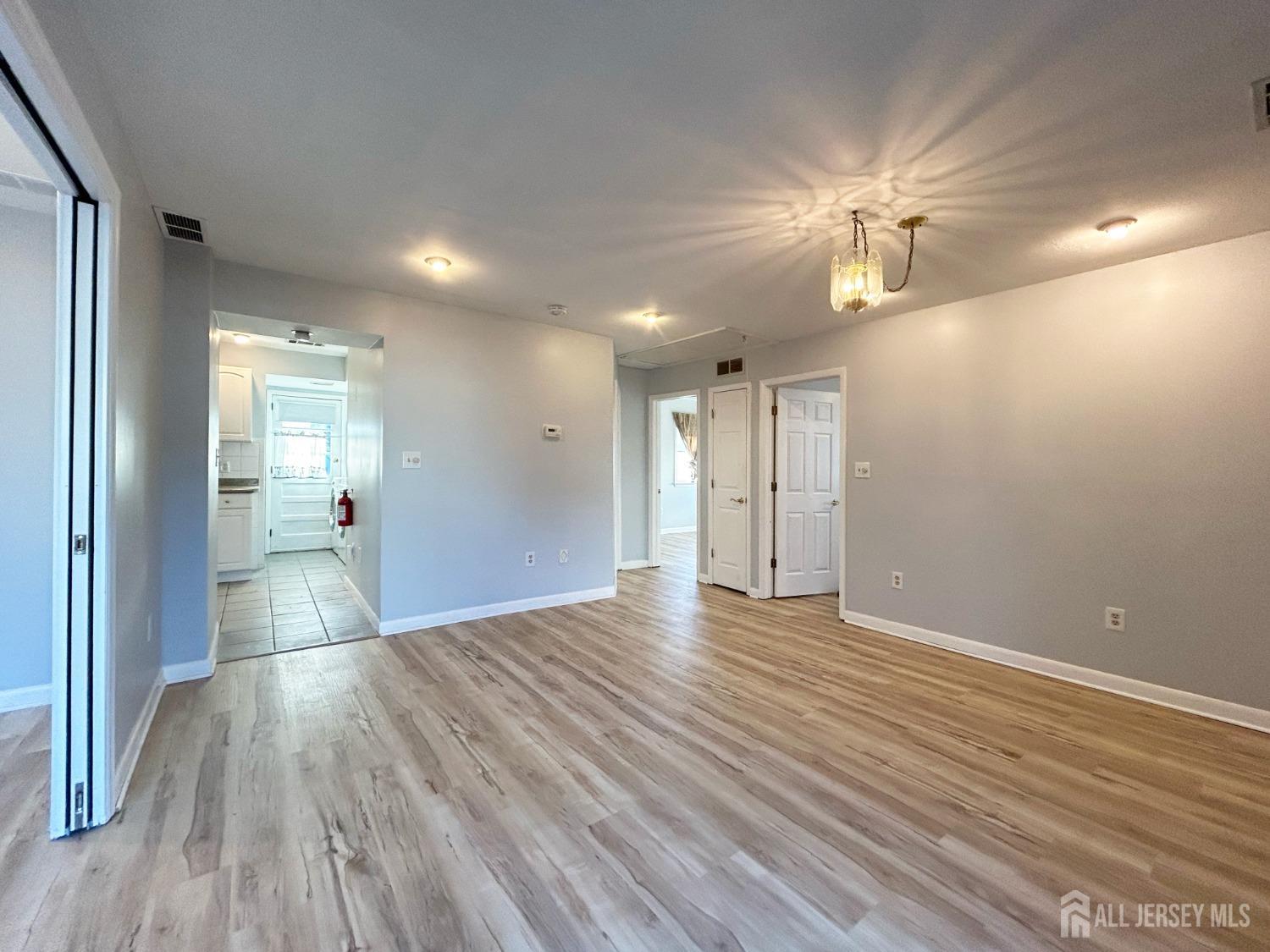 122 Vineyard Road Edison, NJ 08817 - Photo 7 of 19 a view of empty room with wooden floor
