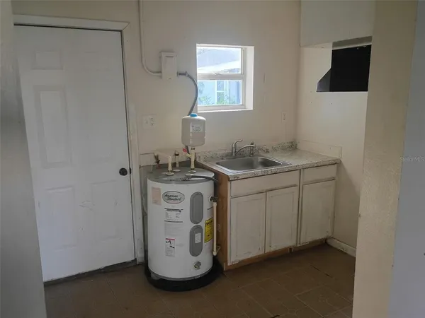 a utility room with a sink a washer and dryer