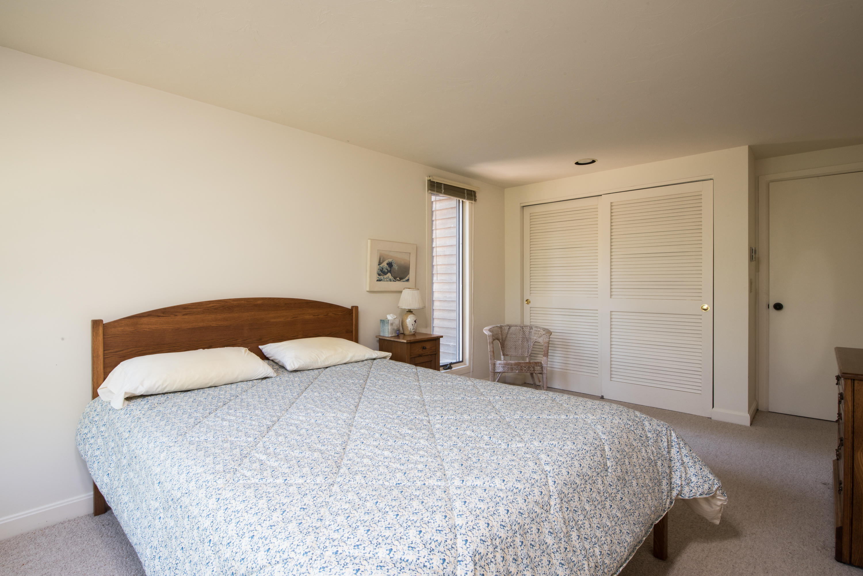 245 King Phillip Road Wellfleet, MA 02667 - Photo 20 of 33 a bedroom with a large bed and walk in closet