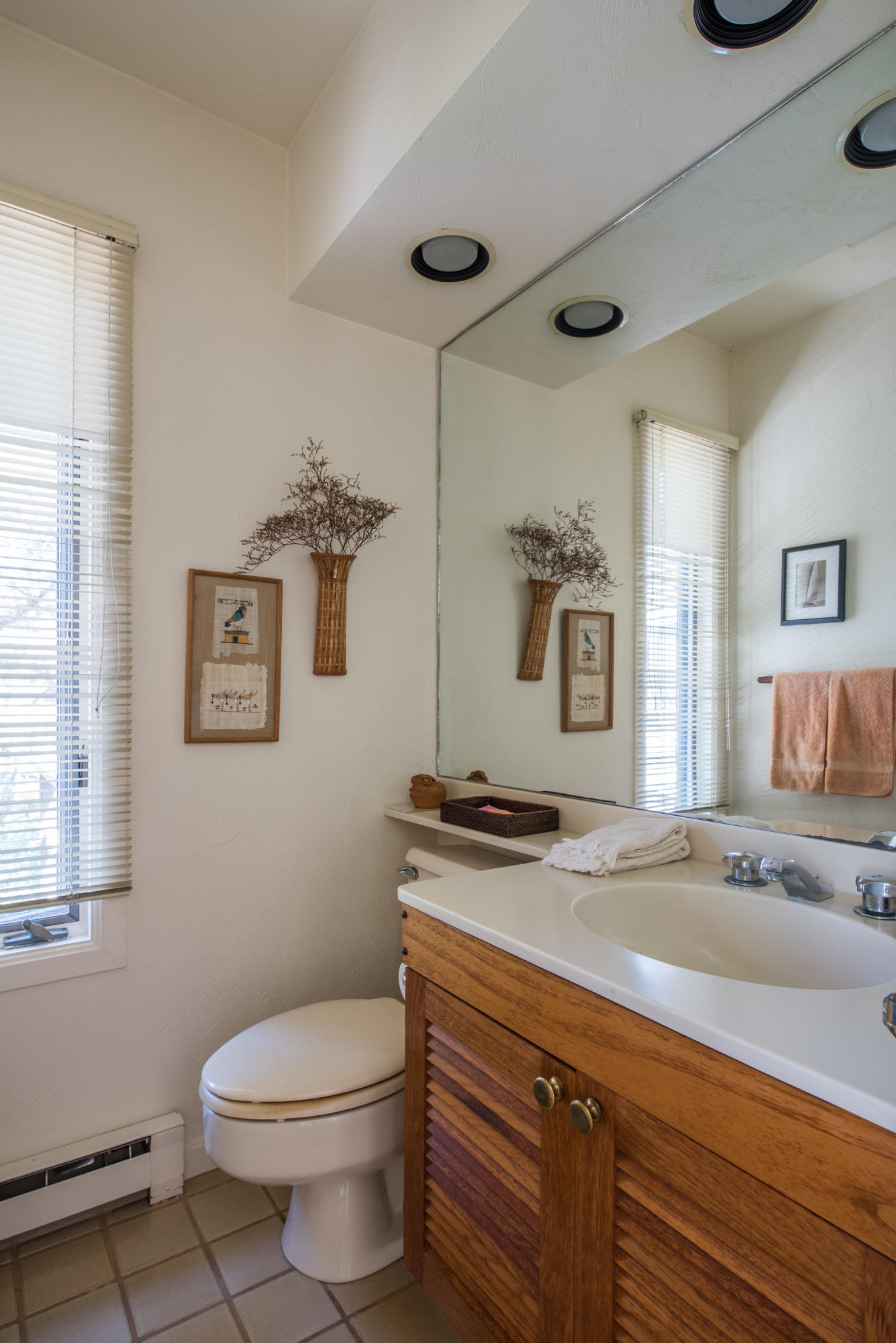 245 King Phillip Road Wellfleet, MA 02667 - Photo 29 of 33 a bathroom with a granite countertop sink a toilet a mirror and a window