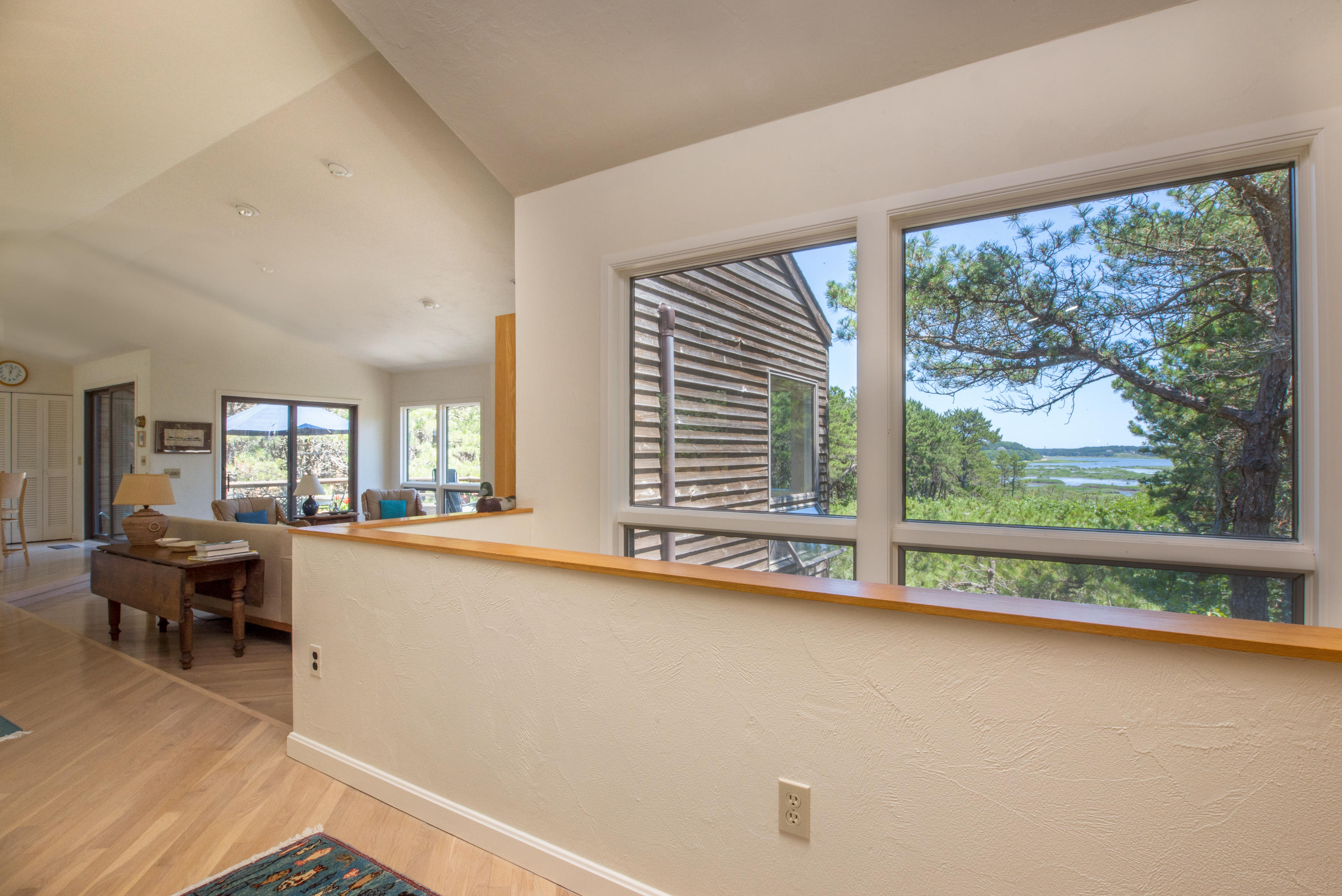 245 King Phillip Road Wellfleet, MA 02667 - Photo 7 of 33 a living room with a large window and table