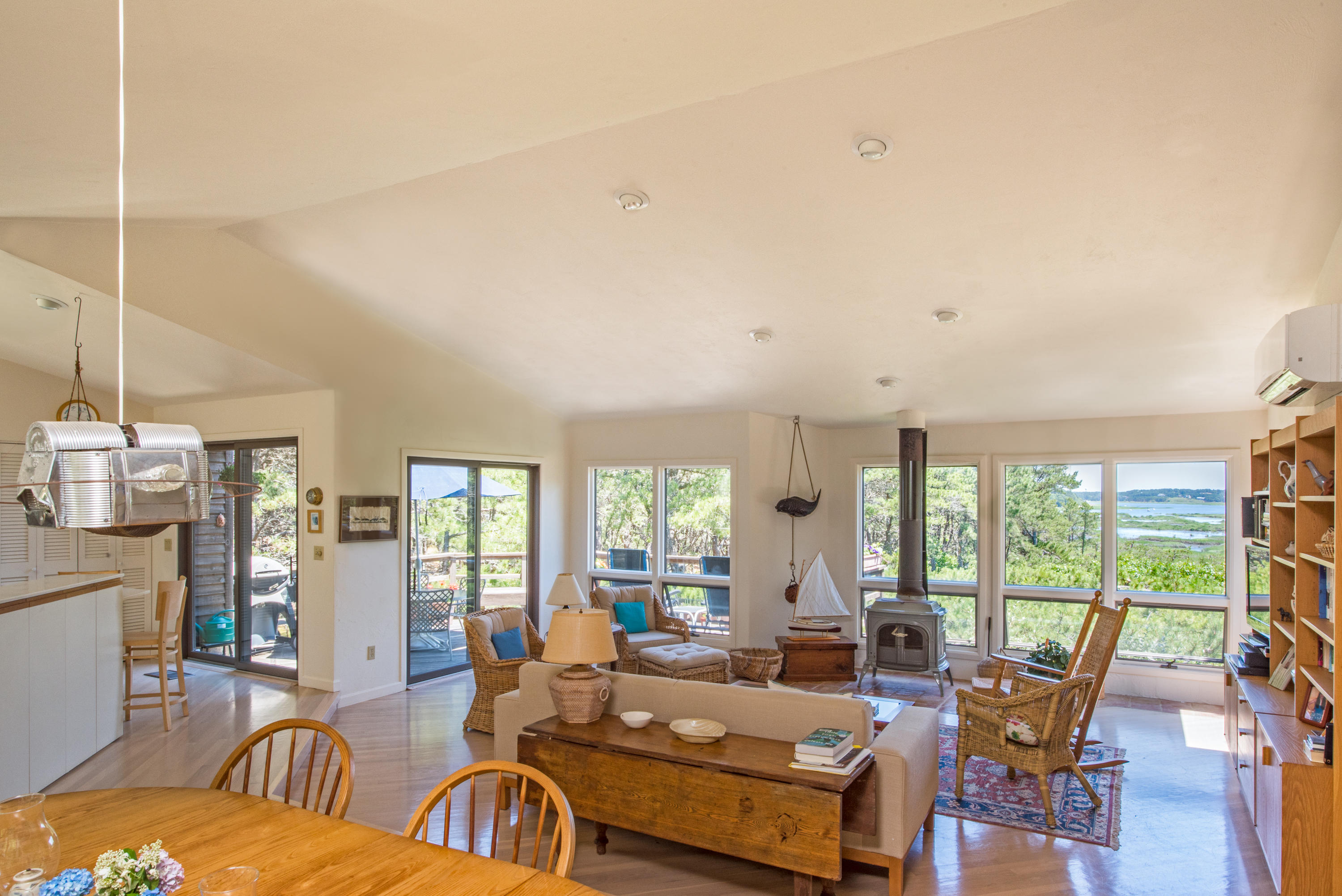 245 King Phillip Road Wellfleet, MA 02667 - Photo 9 of 33 a living room with fireplace furniture and large windows