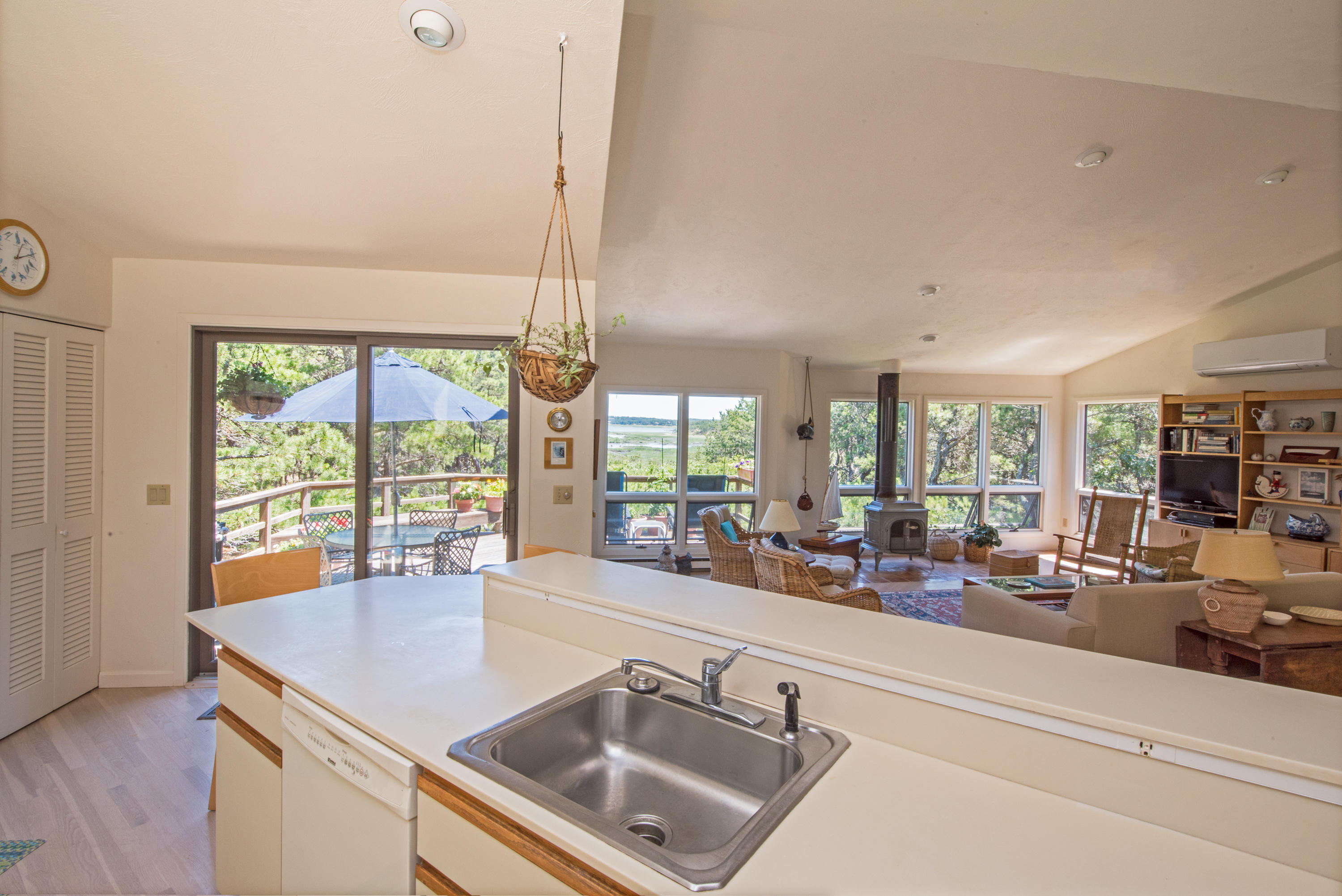 245 King Phillip Road Wellfleet, MA 02667 - Photo 10 of 33 a view of a kitchen with kitchen island a large window cabinets a sink and stainless steel appliances