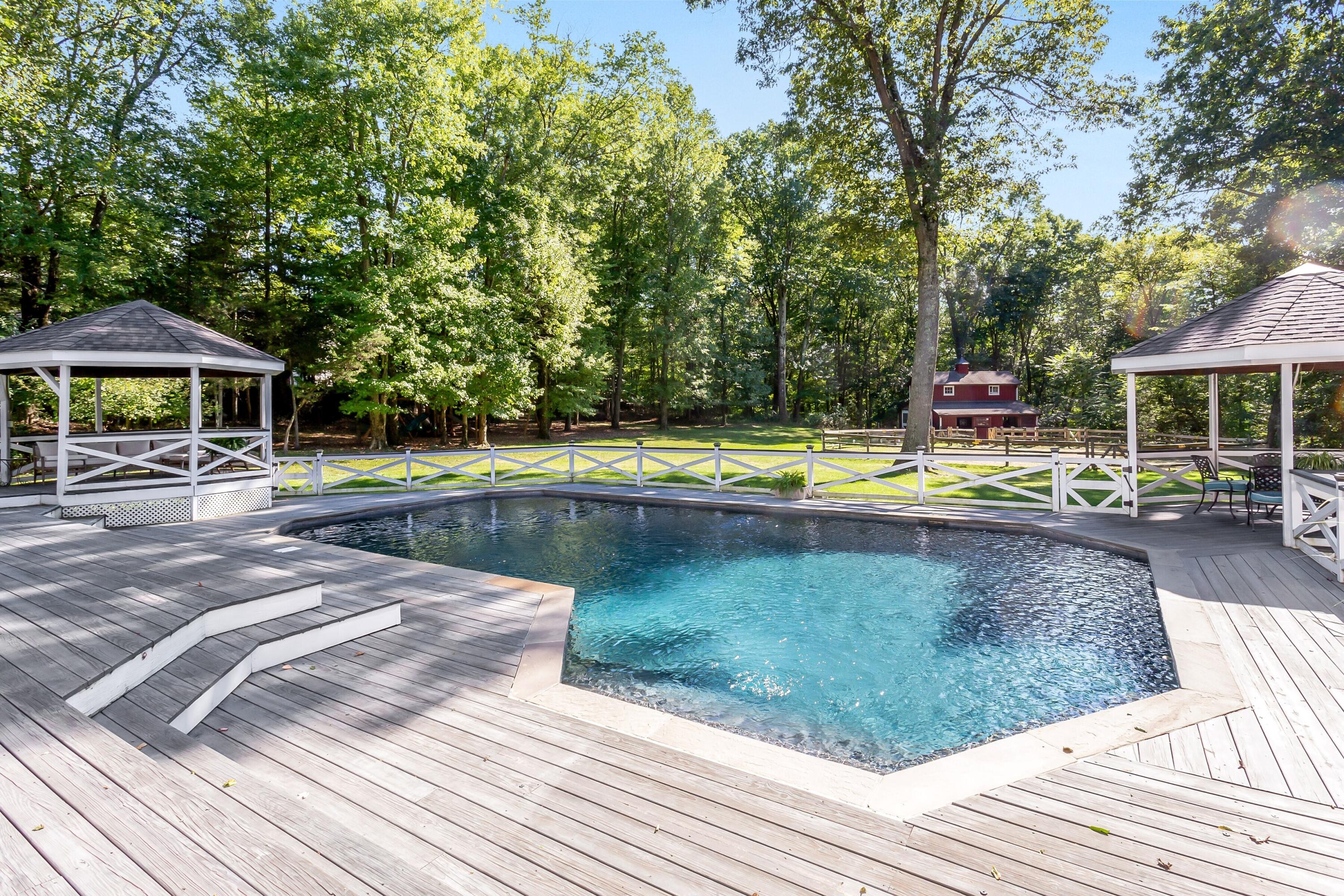 30 Carrington Drive Greenwich, CT 06831 - Photo 39 of 46 a view of a swimming pool with wooden deck and lake view