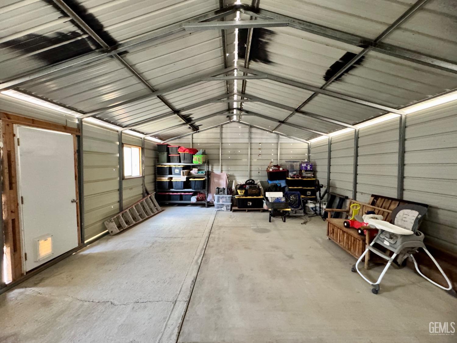 Undisclosed Address Maricopa, CA 93252 - Photo 11 of 33 a view of a garage with furniture
