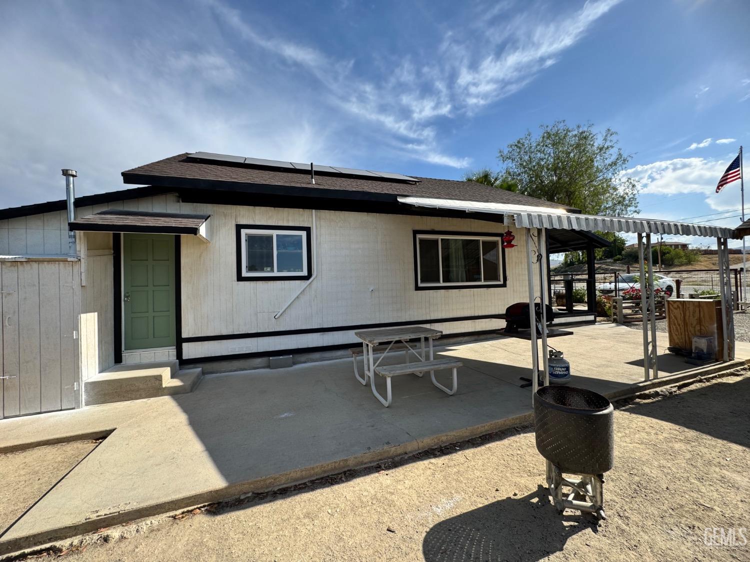 Undisclosed Address Maricopa, CA 93252 - Photo 13 of 33 a living room with a table and chairs