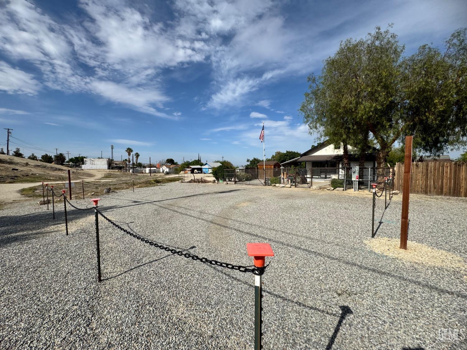 Undisclosed Address Maricopa, CA 93252 - Photo 14 of 33 a street sign on a sidewalk next to a building