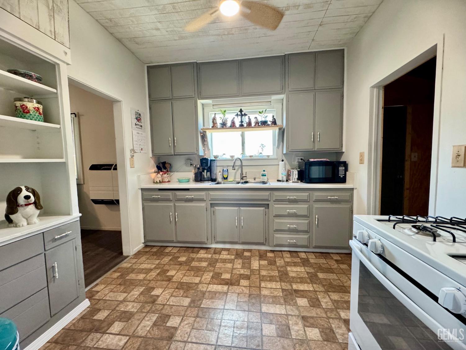 Undisclosed Address Maricopa, CA 93252 - Photo 18 of 33 a kitchen with a stove a sink and a refrigerator