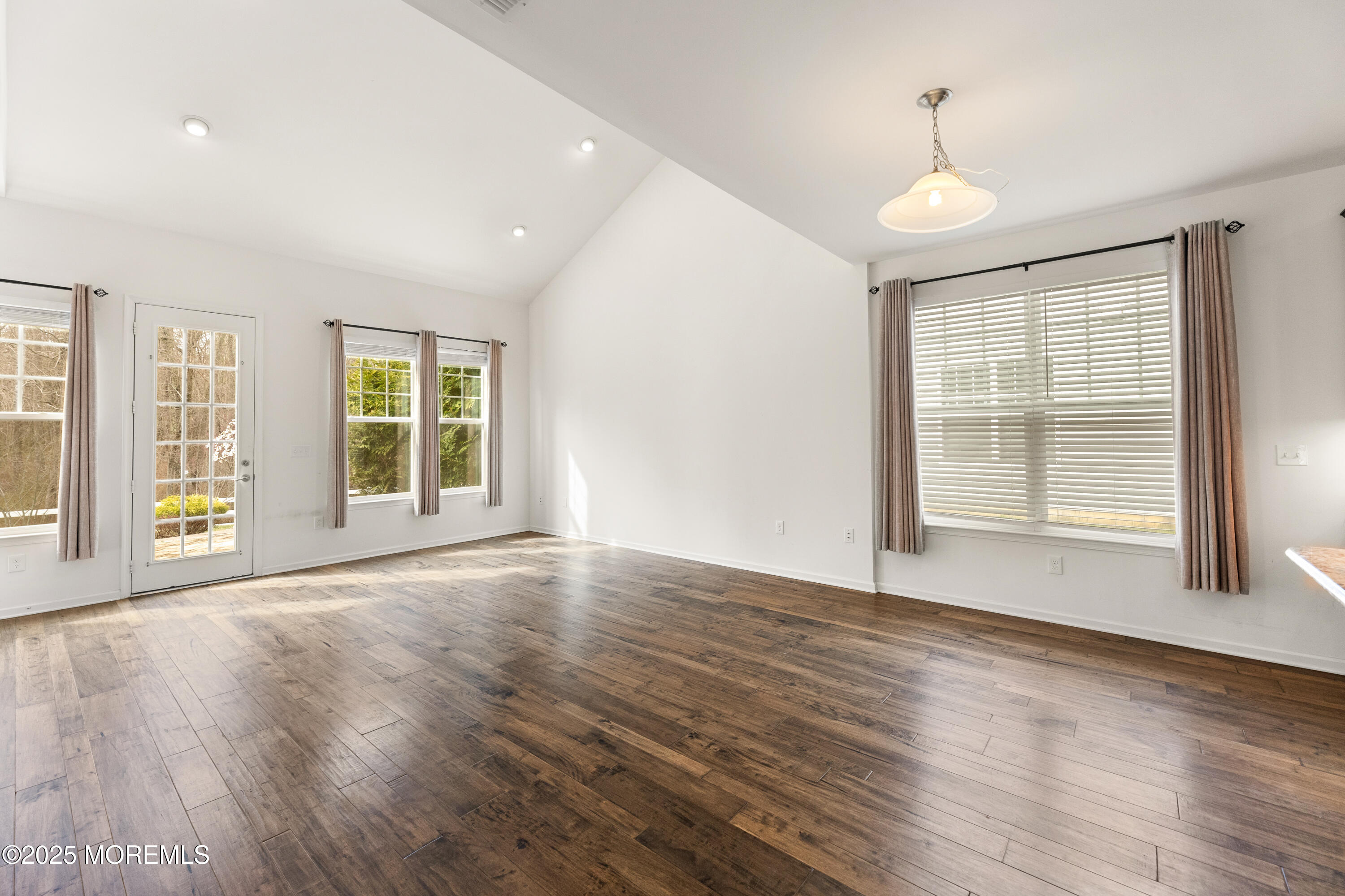 58 Harvest Ridge Road Howell, NJ 07731 - Photo 23 of 53 a view of an empty room with wooden floor and a window