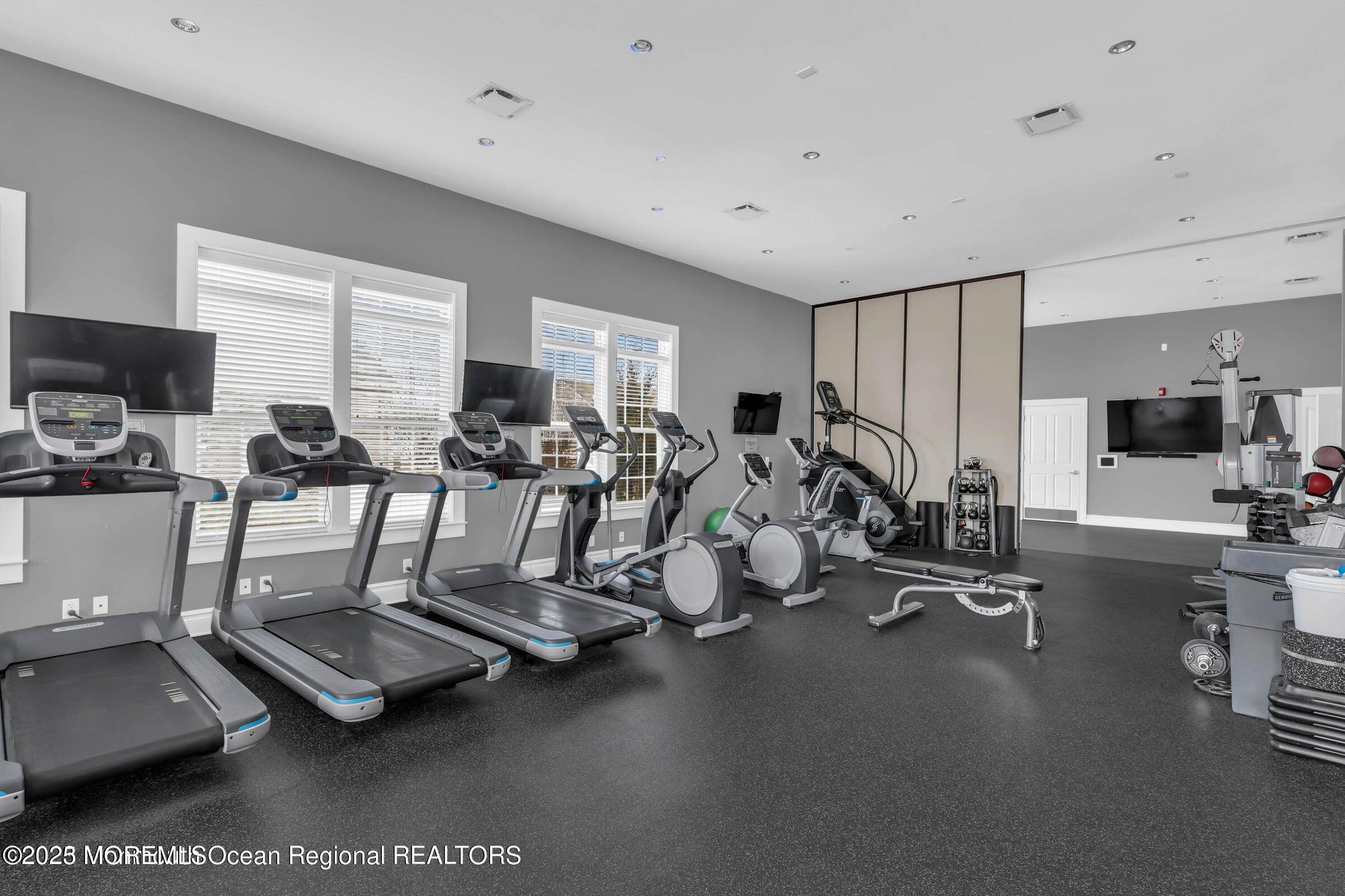 58 Harvest Ridge Road Howell, NJ 07731 - Photo 47 of 53 a room with gym equipment and a large window
