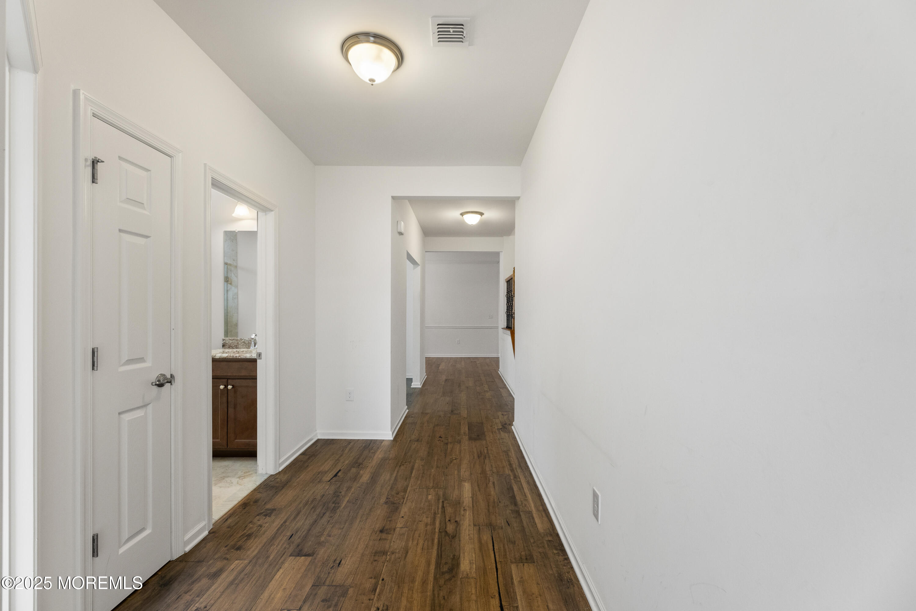 58 Harvest Ridge Road Howell, NJ 07731 - Photo 6 of 53 a view of a hallway with wooden floor and a bathroom