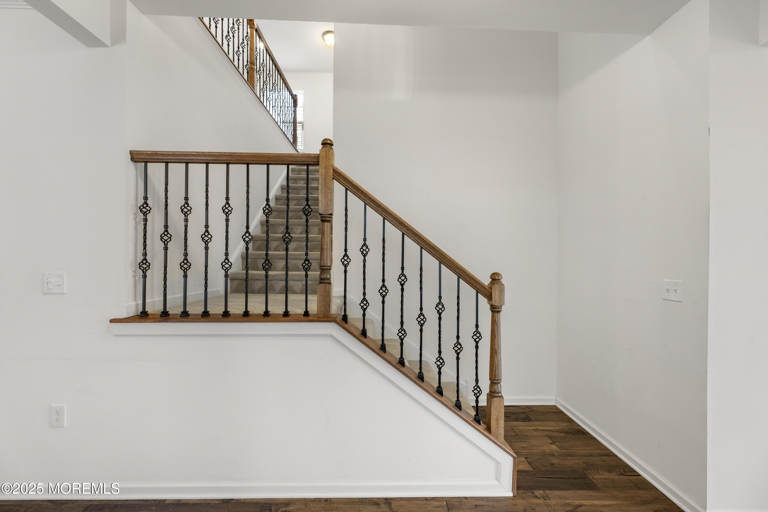 58 Harvest Ridge Road Howell, NJ 07731 - Photo 9 of 53 a view of a hallway with wooden floor and stairs