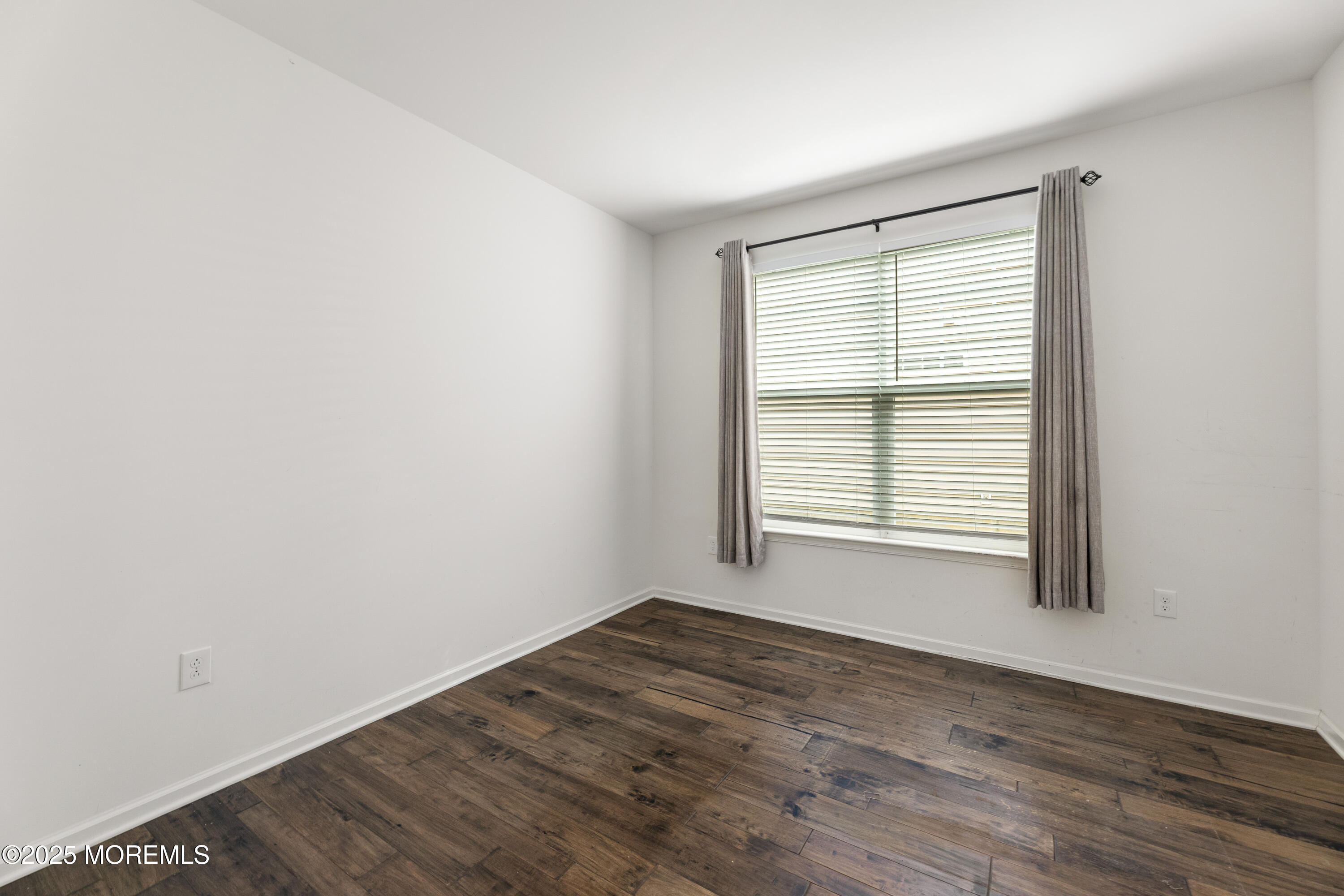 58 Harvest Ridge Road Howell, NJ 07731 - Photo 10 of 53 a view of an empty room with wooden floor and a window