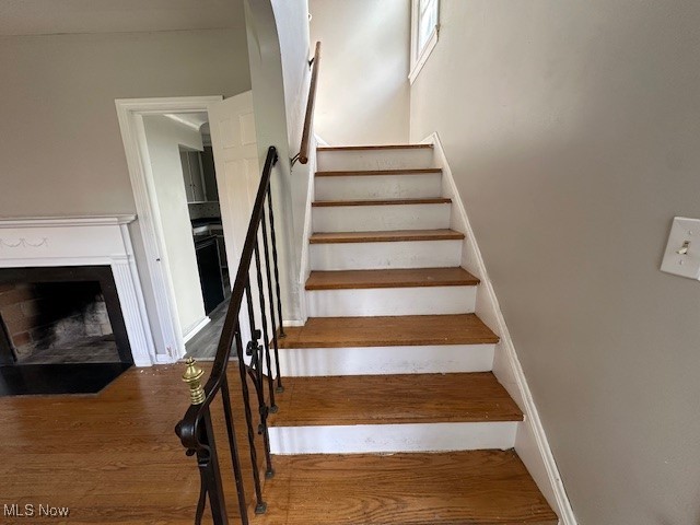 1183 Argonne Road Cleveland, OH 44121 - Photo 8 of 18 Stairway featuring wood finished floors and a fireplace