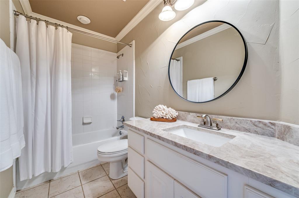 2841 Winding Creek Road Prosper, TX 75078 - Photo 27 of 40 a bathroom with a granite countertop toilet a sink and a mirror