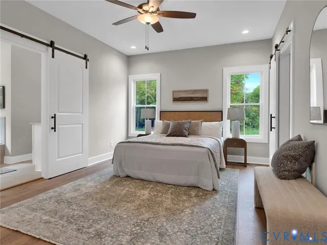 a bedroom with a large bed and a window