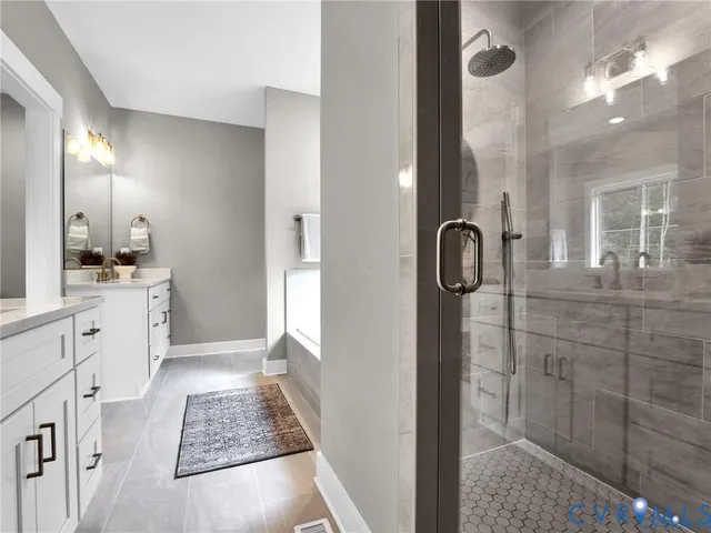 a bathroom with a double vanity sink mirror and shower