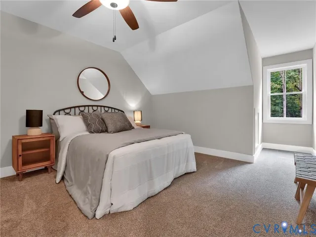 a bedroom with a large bed and window