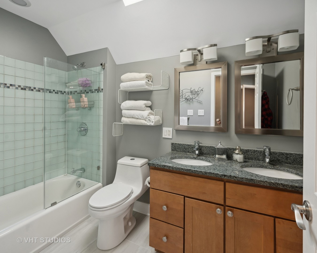 1750 West School Street Chicago, IL 60657 - Photo 17 of 37 a bathroom with a granite countertop toilet sink and mirror
